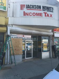 business establishment with a boarded up plywood window